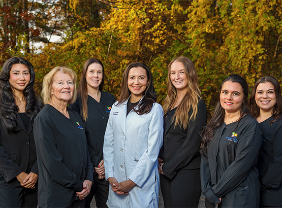 The Shawsheen Family Dental team smiling in front of trees