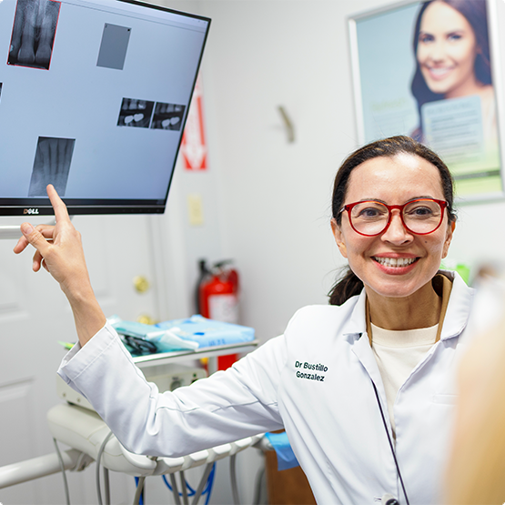 Doctor Bustillo-Gonzalez showing a patient an x-ray of their teeth