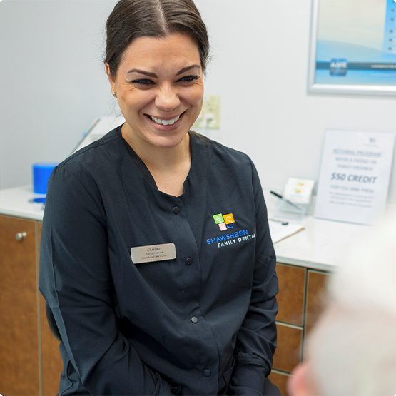Dental team member smiling at a patient