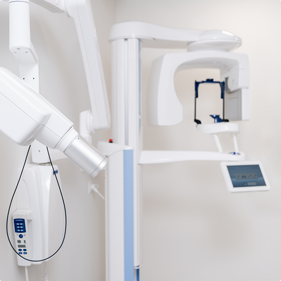 CT cone beam scanner standing against a white wall