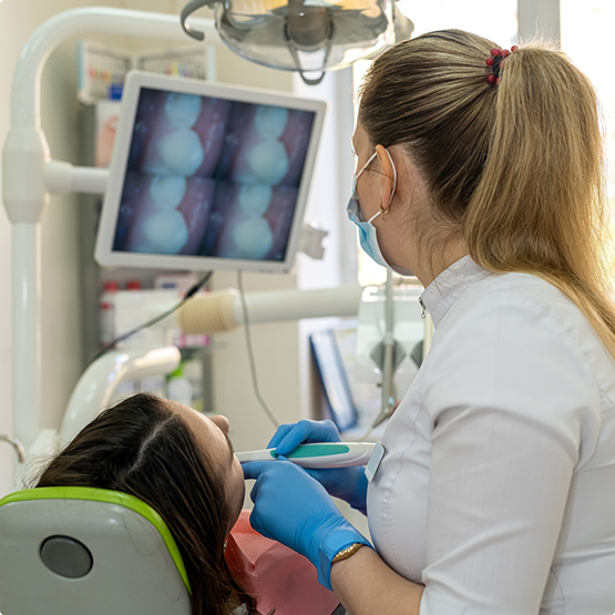 Dentist taking close up photos of a patient's teeth