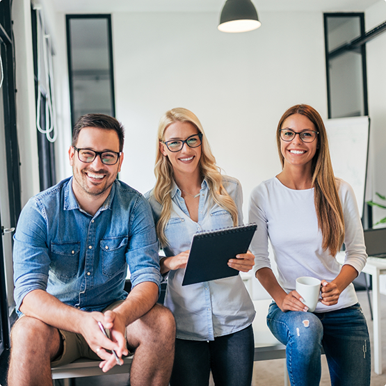 Three adults smiling in an office