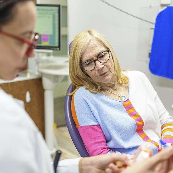 Dentist showing a model of the teeth to a patient