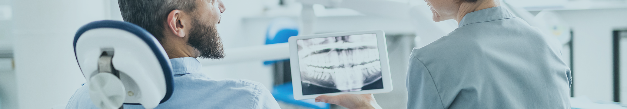 Dentist showing a patient an x-ray of their teeth