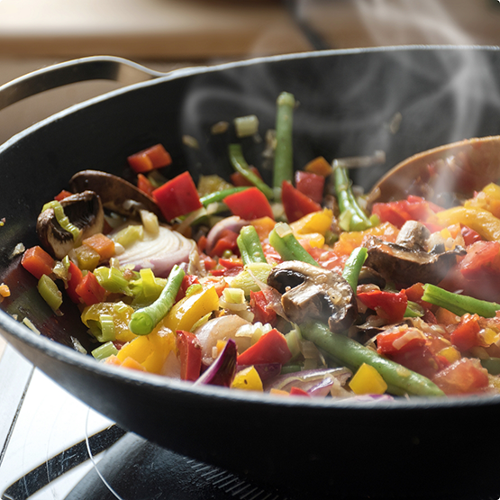 Sizzling pan of vegetable stir fry