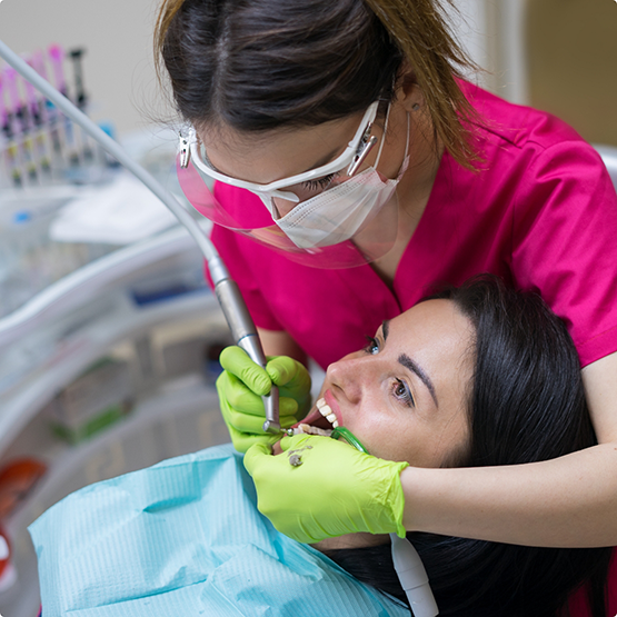 Woman having her teeth examined by her dentist
