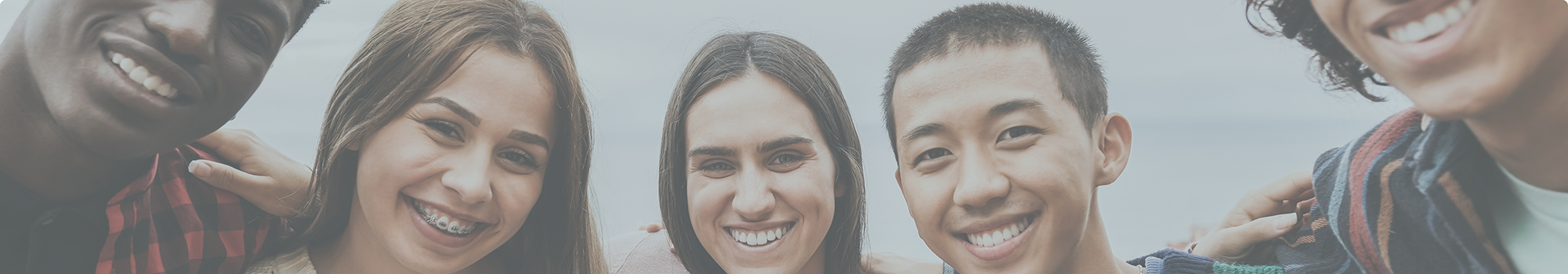 Three young adults smiling after restorative dentistry treatment in Tewksbury