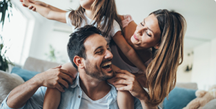 Family of three playing in their living room