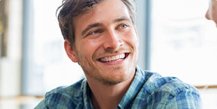 Smiling man in a blue plaid shirt