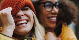 Two women in winter clothing laughing