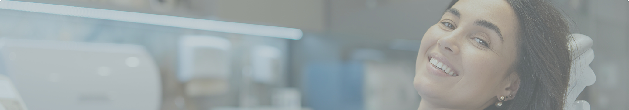 Woman smiling in the dental chair after TMJ treatment in Tewksbury